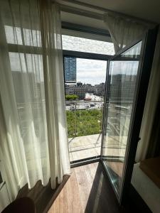 a room with a window with a view of a city at Roxi Roosevelt in Antwerp