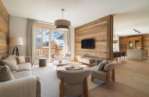 a living room filled with furniture and a flat screen tv at Guernerés & Spa by Alpine Resorts in Grimentz