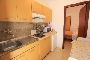 a small kitchen with a sink and a microwave at IDA St2, FEW STEPS FROM THE BEACH in Novigrad Istria