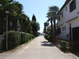 an empty street with palm trees and a building at IDA St2, FEW STEPS FROM THE BEACH in Novigrad Istria