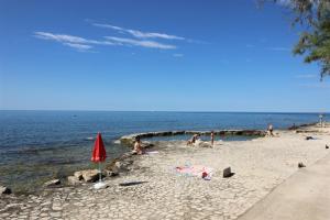 a group of people on a beach near the water at IDA St2, FEW STEPS FROM THE BEACH in Novigrad Istria +6 photos
