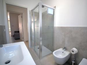 a bathroom with a shower and a sink and a toilet at SIT Holiday Homes in Lido delle Nazioni +84 photos
