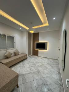a living room with a couch and a tv on the ceiling at Cozy Corner in Sousse