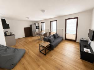 a living room with a couch and a table at Apartmán Lidická bouda in Pec pod Sněžkou