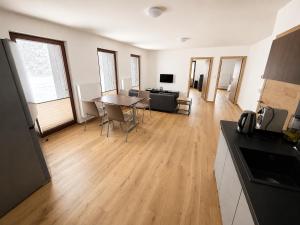 a large living room with a table and chairs at Apartmán Lidická bouda in Pec pod Sněžkou +6 photos