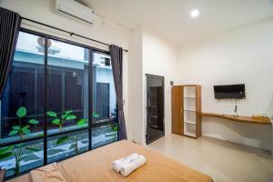 a living room with a large window with a fish tank at Timeless Sevilla Luxe in Ngemplak