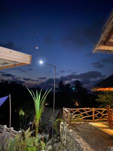 a street light in front of a house at night at Batukaras beach hill villas in Batukaras