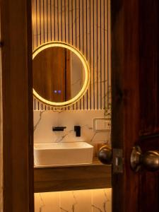 a bathroom with a sink and a mirror at Black Pearl View in Himandhoo  +1 photo