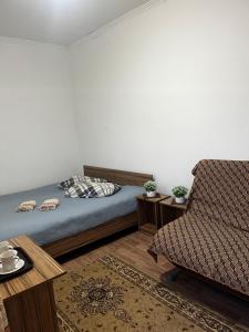 a bedroom with a bed and a chair at Kubat in Bosteri