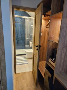 an open door to a bathroom with a toilet at Winnica Tenczyn in Grojec +37 photos