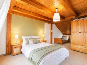 a bedroom with a large bed and a wooden ceiling at Dom Wakacyjny Brenna in Brenna