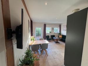 a kitchen with a table and chairs and a living room at Kramerhof in Groß Fredenbeck +10 photos