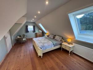 a bedroom with a bed and a large window at Kramerhof in Groß Fredenbeck
