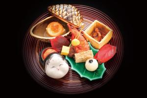 a red plate of food on a black at Enraku in Kurobe