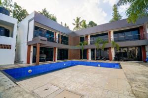 an exterior view of a house with a swimming pool at Timeless Sevilla Luxe in Ngemplak
