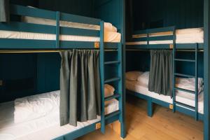 a group of bunk beds in a room at Base Camp Hathersage, YHA Partner in Hathersage