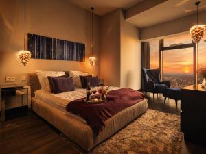 a bedroom with a large bed and a desk and chair at Apartamenty Sky Tower in Wrocław +162 photos