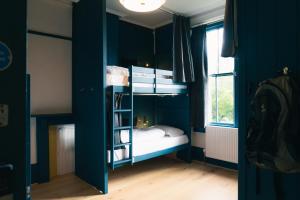 a bedroom with two bunk beds and a window at Base Camp Hathersage, YHA Partner in Hathersage