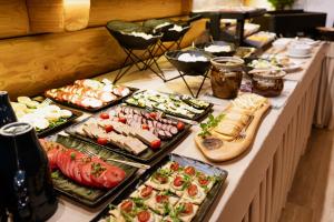 a buffet with many different types of food on a table at Willa Baciarka-widok, basen, sauna, jacuzzi in Kościelisko