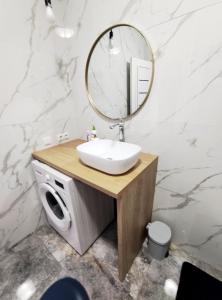 a bathroom with a sink and a mirror on a counter at Ap Blessedplace Rîșcani-New Bldg in Chişinău +15 photos
