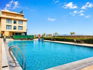 a large swimming pool in front of a building at Sterling Pushkar in Pushkar