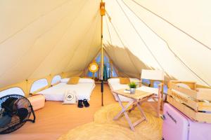 a tent with a bed and a table in it at Kampaoh Estepona in Estepona