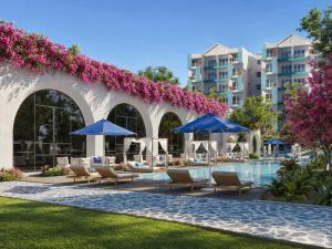 a pool at a resort with chairs and umbrellas at Signature 2BR - Deluxe - Santorini - Negombo in Negombo +23 photos
