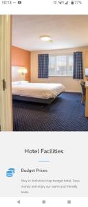 a hotel room with a bed in a room at Cosy Inn in Mirfield