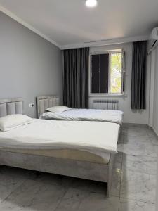 a bedroom with two beds and a window at 名宿 395 Hostel in Bishkek