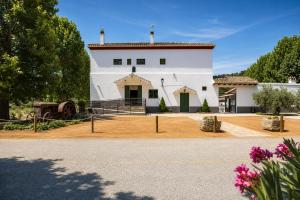 a white building with a red roof at Molino de Búlar - 1920 Olive Oil Mill Heritage in Piñar
