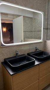 a bathroom with two sinks and a large mirror at Cloffy et son Domaine in Nouans-les-Fontaines +29 photos