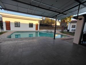a swimming pool in the middle of a house at The Lantern Porch Guesthouse in Vryburg