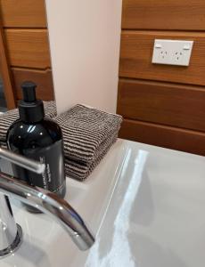 a bathroom sink with a bottle of soap on it at Athol Country Bed & Breakfast - Entire Guest Wing in Athol