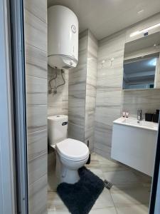 a bathroom with a toilet and a sink at Little Studio Prespa Best Location in Varna City +2 photos