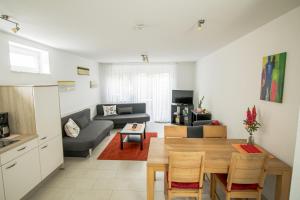a living room with a table and a couch at Murthum Apartments in Leinfelden-Echterdingen