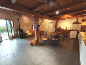 a room with a kitchen and a table and chairs at Gîte bergerie in Bargème