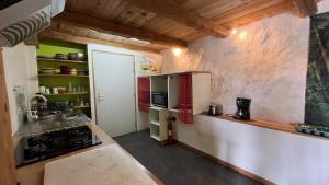 a kitchen with a red refrigerator and a sink at Gîte bergerie in Bargème +37 photos