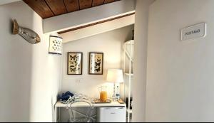 a kitchen with white walls and a table with a lamp at Maison La Torretta in Vico Equense +47 photos