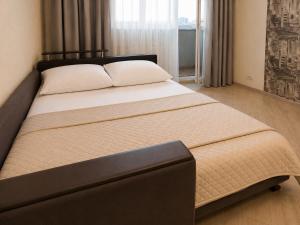 a bedroom with a large bed with a black headboard at Luxury 3 Rooms Apartments in Center by Green House in Poltava