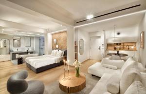 a large living room with a bed and a couch at AIONION RESIDENCES by K&K in Athens
