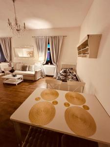 a living room with a table and a couch at Farma P&P Apartmány in Vrchovany