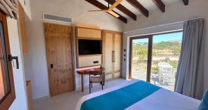 a bedroom with a bed and a desk and a tv at Hotel Club Sunway Punta Prima in Es Pujols