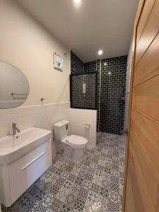 a bathroom with a toilet and a sink and a shower at Langbaan cafe and homestay in Ban Mai +28 photos