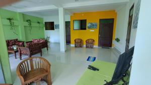 a living room with chairs and a dining room at Jagabay Resort & Surfing School in Weligama