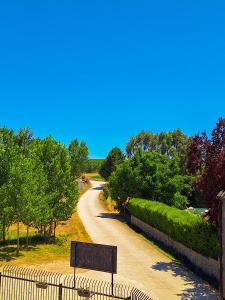 a road with a fence and a sign on it at Hotel-Albergue Puente Fitero in Itero de la Vega