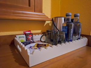 a shelf with two bottles of wine and other items at Hotel-Albergue Puente Fitero in Itero de la Vega