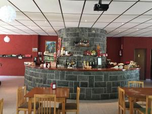 a bar in a restaurant with a stone wall at El Chate Tiendas in Sarvisé +43 photos