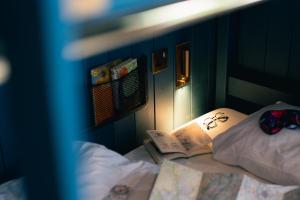 a bedroom with a bed with a book on it at Base Camp Hathersage, YHA Partner in Hathersage