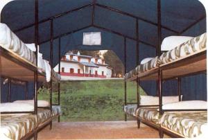 a painting of three bunk beds with a house in the background at El Chate Tiendas in Sarvisé