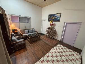 a living room with a couch and a table at The Hp 39 House in Dharmsāla